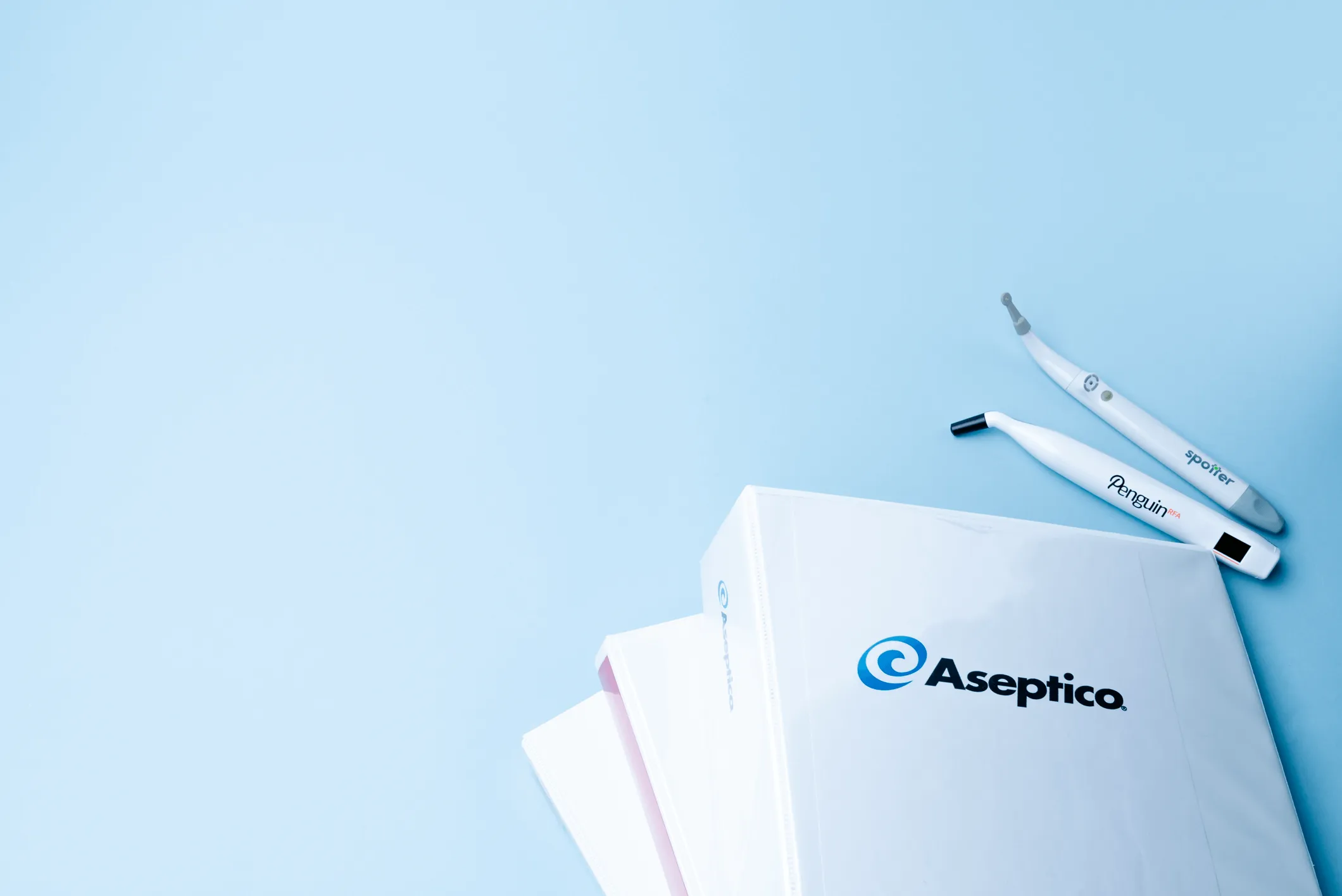 Decorative photo banner of implant tools and some binders with the aseptico logo on them