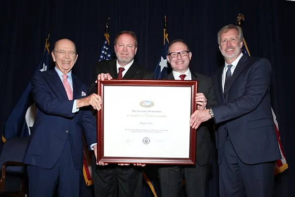 Our Aseptico team receiving the President's E award and holding in together for a photo