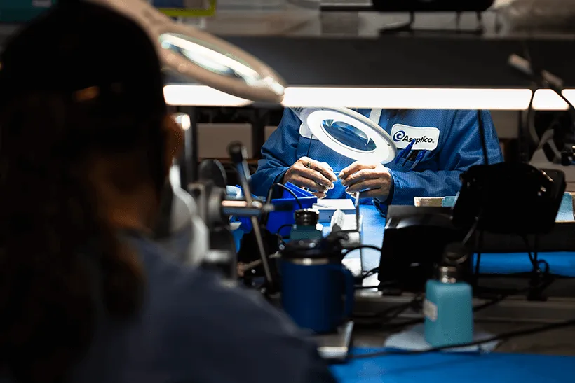 photo of two aseptico employees working on making a dental motor